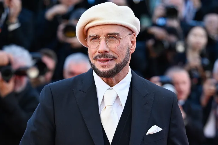 John Travolta Cannes 2026 Beret Look — The Viral Fashion Moment With the Most Heartwarming Story Behind It John Travolta navy beret Cannes