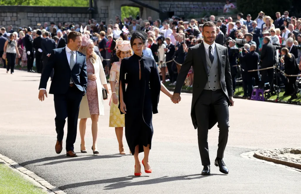 Victoria Beckham Style Evolution — From Spice Girl to Global Fashion Icon David and Victoria Beckham followed by Johnny Wilkinson (L) arrive at St George’s Chapel at Windsor Castle before the wedding of Prince Harry to Meghan Markle on May 19, 2018 in Windsor, England.